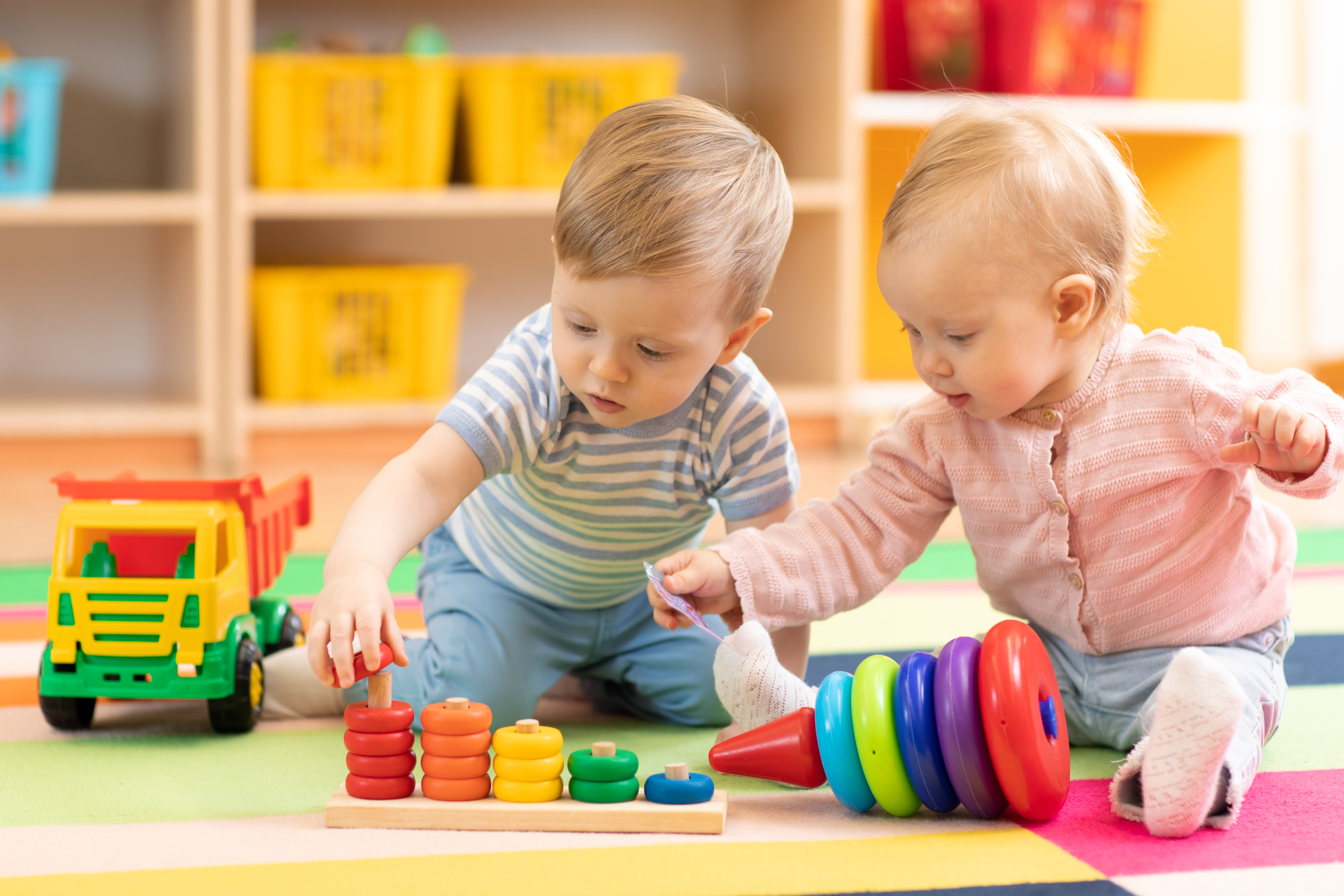 Two toddlers playing together in a crèche