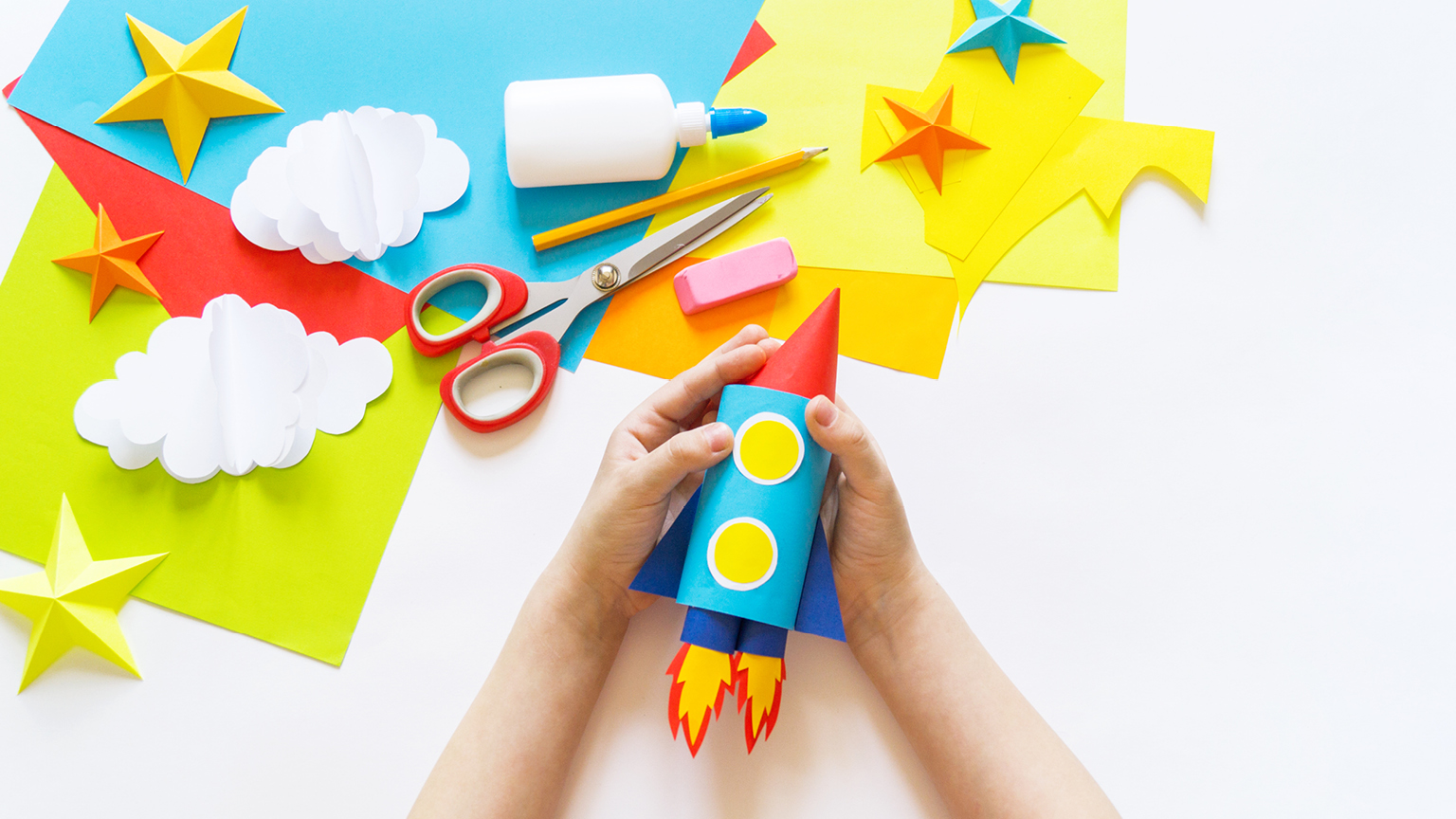 Children's craft activity building a paper rocket ship