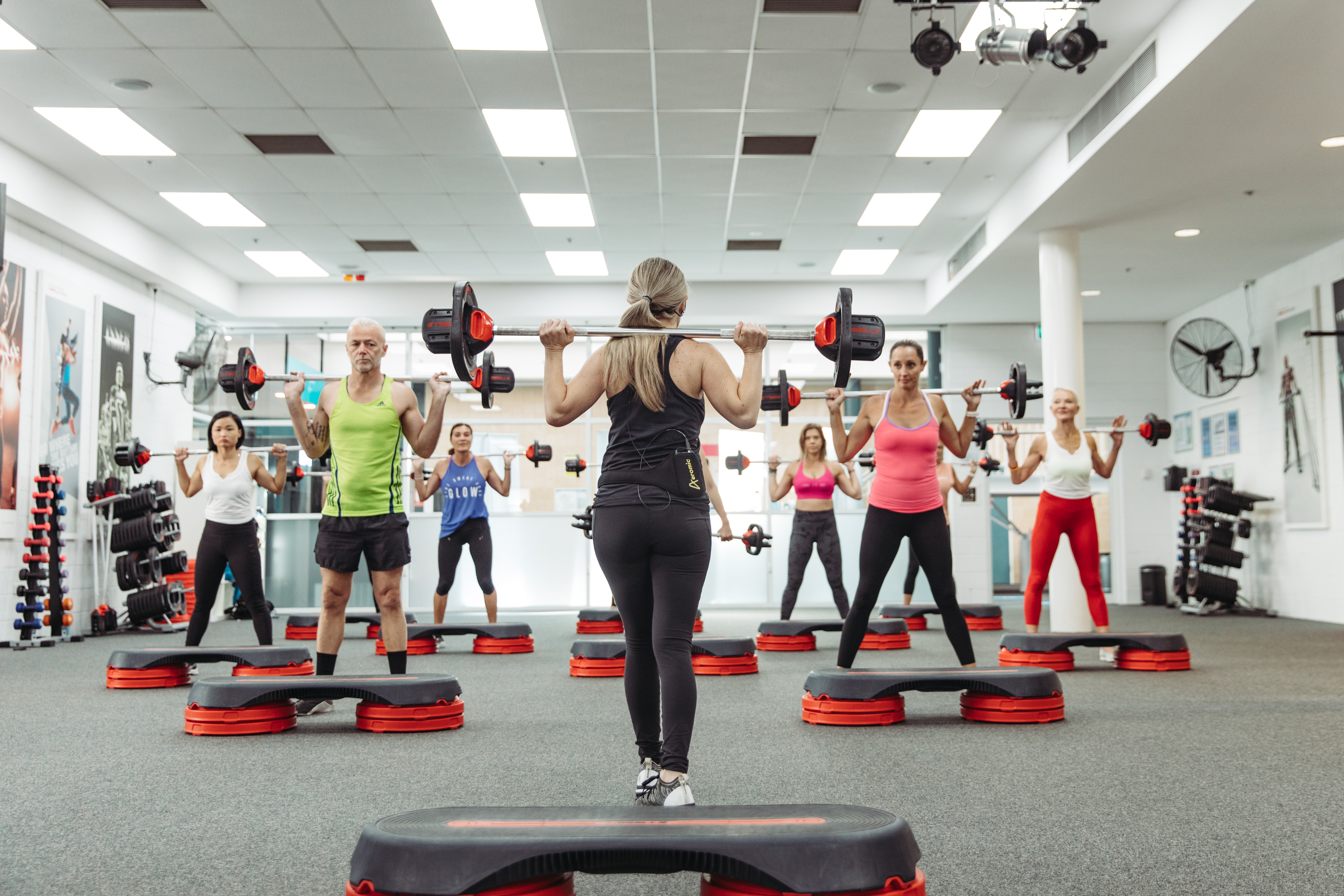 Fitness instructor leading a group fitness class