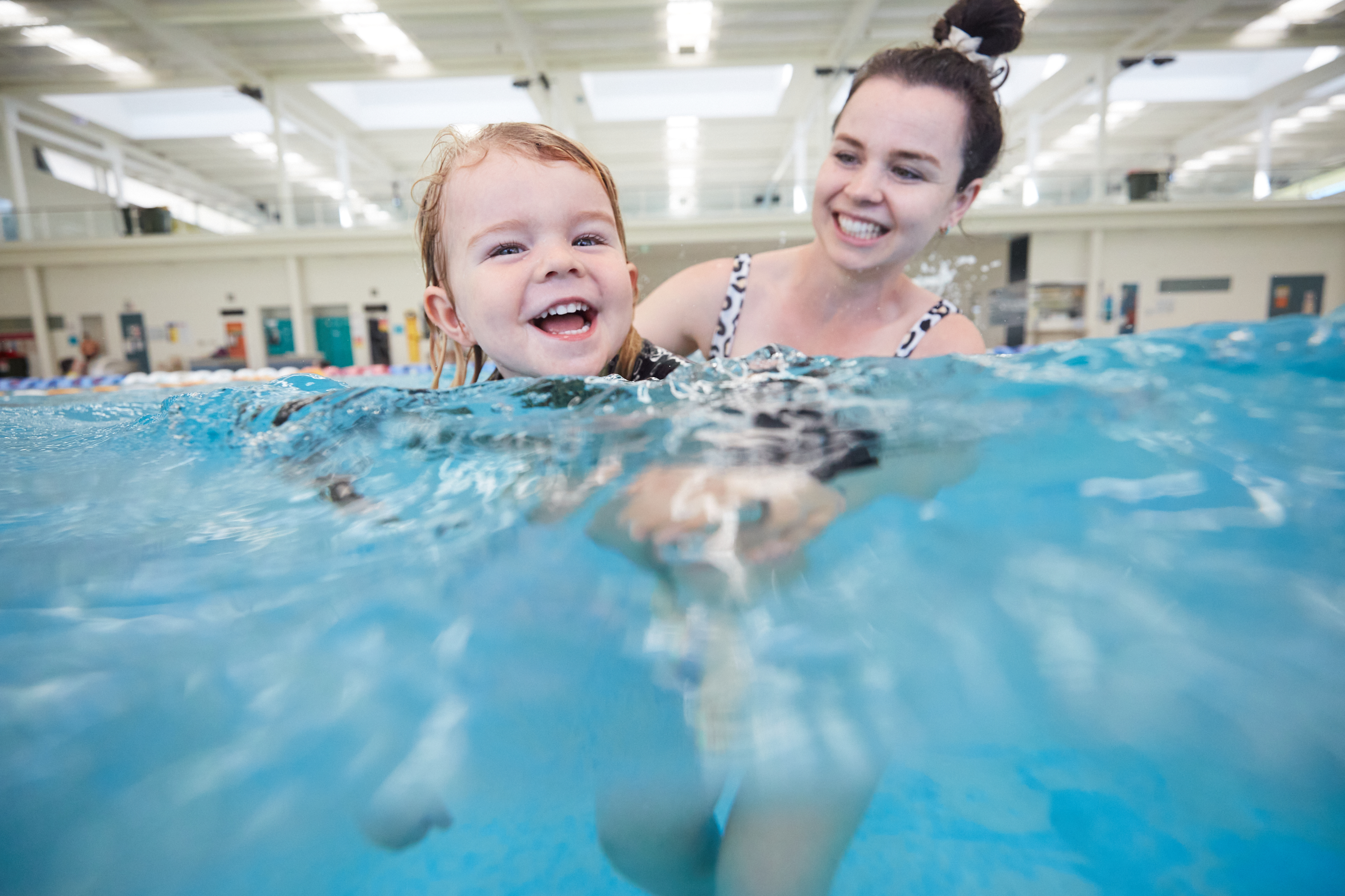 Happy mum and son playing together in HBF Arena's aquatic centre