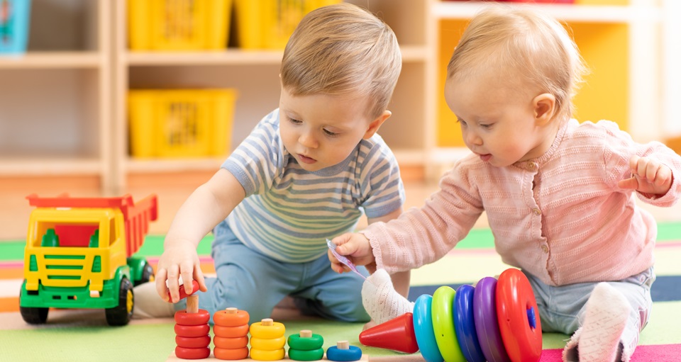 Babies playing with blocks and toys